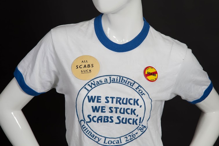 Culinary Union members pinned “scab” buttons to their shirts in opposition to non- union workers hired by casinos during strikes. The t-shirt was worn by a "jailbird" during the 1984 strike, after many protesters were arrested during the pickets that year.